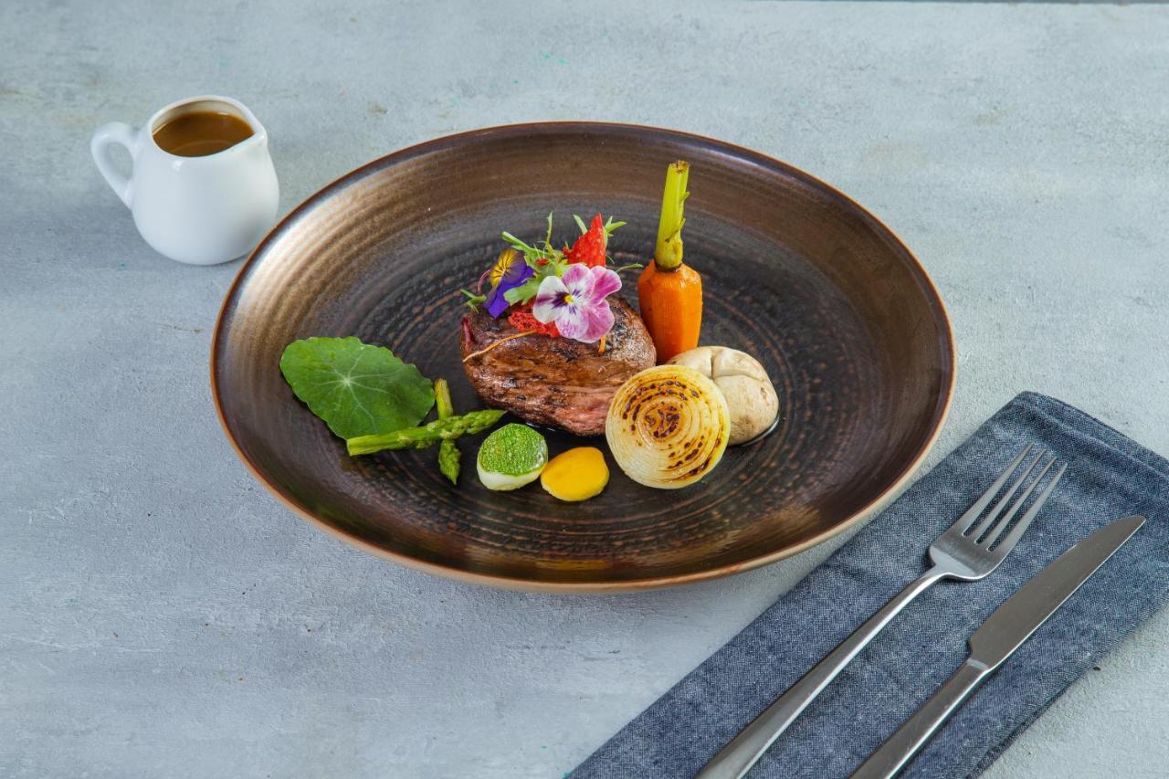 فندق ذا أورينتال جايد هانوي المظهر الخارجي الصورة A steak prepared with edible flowers